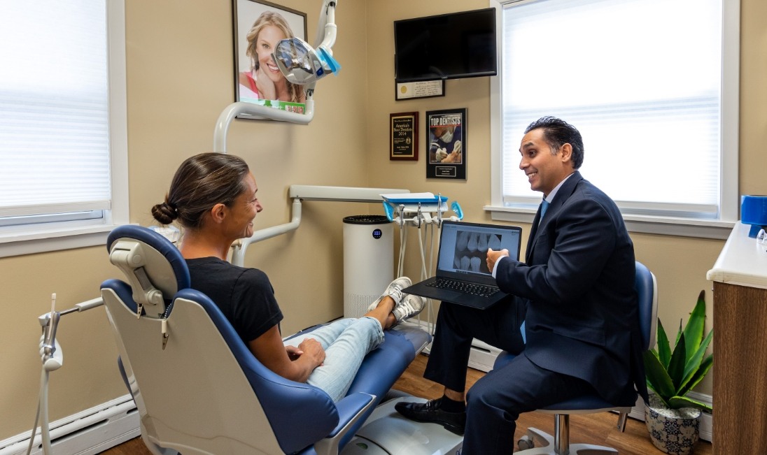 Doctor Vahid talking to a patient in his Ramsey New Jersey dental office