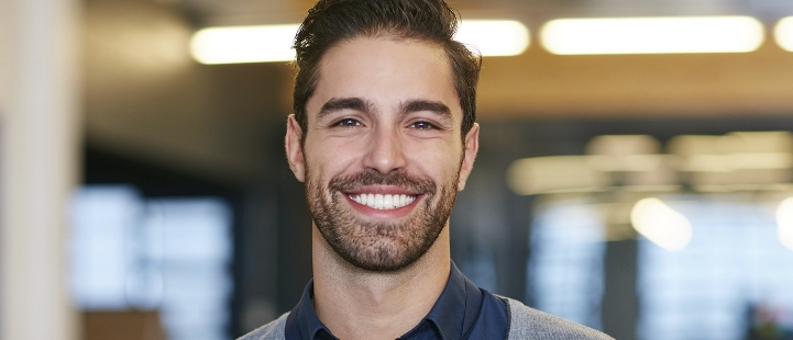 Smiling young man wearing business casual attire