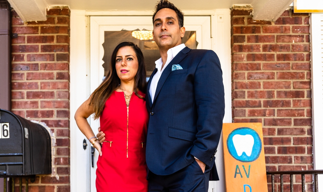 Doctor Vahid standing on front porch with his wife