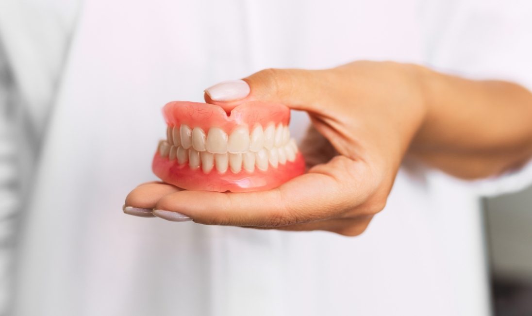 Dentist holding a set of dentures