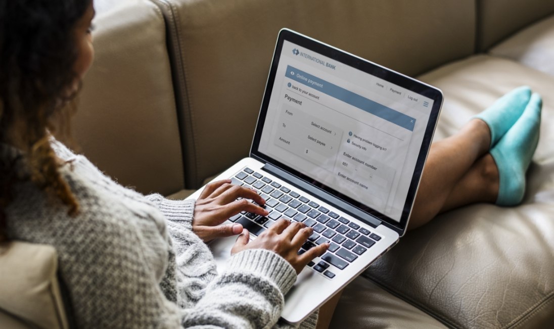 WOman filling out payment forms on laptop