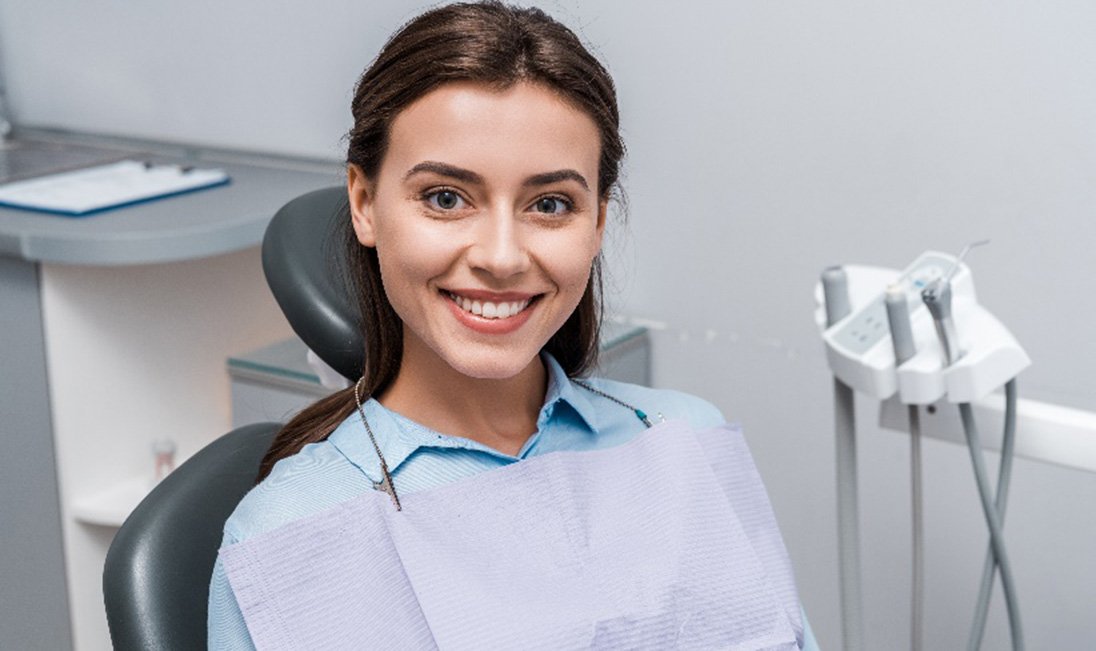 Woman smiling while sitting in dentist's treatment chair