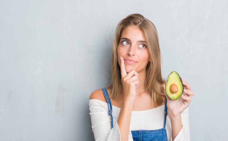 a woman with veneers thinking about her diet